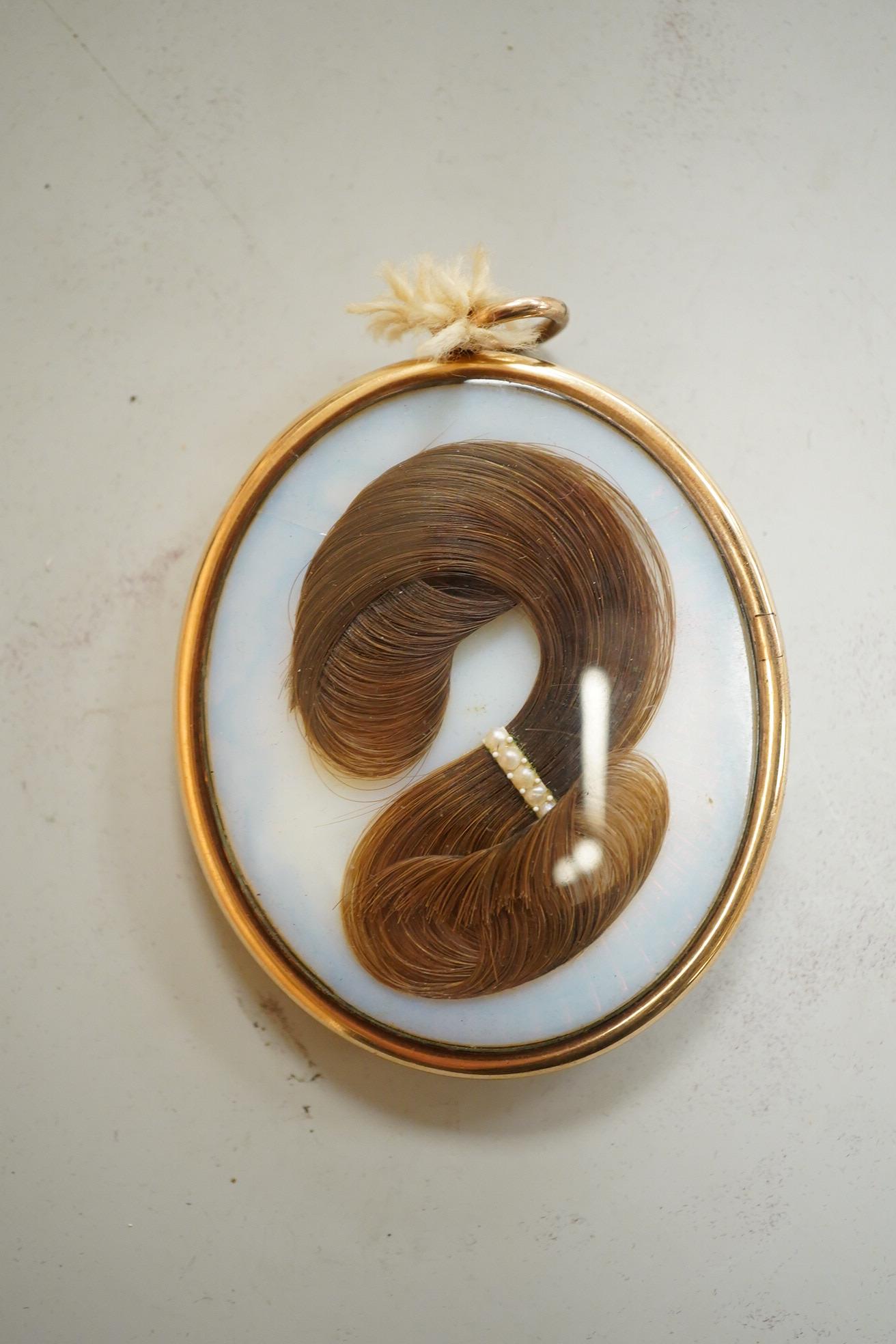 Regency School, Portrait miniature of a young gentleman, oval watercolour on ivory, housed in a yellow metal pendant frame with hairwork panel verso, glass loose, overall 7cm high - IVORY SUBMISSION BKCK66FM